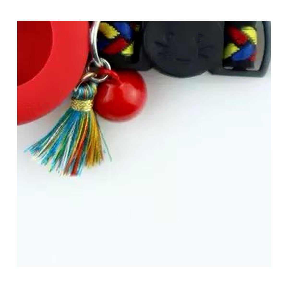 Jingle bell and rainbow tassel charm on an ipetbliss AirTag cat collar