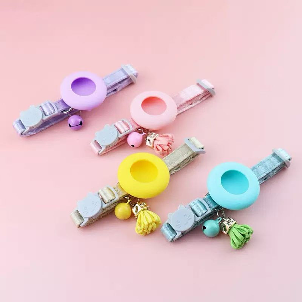 Four pastel velvet AirTag cat collars in lilac, blush, butter, and mint