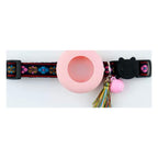 Floral strap with a blush silicone AirTag holder on a white background